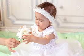 Children photography disney characters fictional characters disney princess islamic wedding style fashion flowers. Baby Girl In White Dress Taking A Beautiful Single White Flower Stock Photo Picture And Royalty Free Image Image 128807070