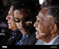 Isaac Farris, center, SCLC President and nephew of the Rev. Dr. Martin  Luther King Jr., former U.N. Ambassador Andrew Young, left, and the Rev.  Joseph Lowery listen to praise for the late