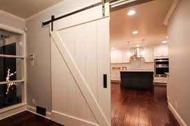 white wooden sliding barn door entering