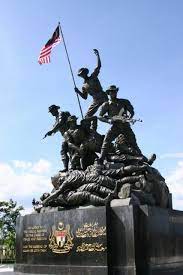 So it might naturely grow in there or somebody did indeed planted in. National Monument Tugu Negara Erected In Memory Of Fallen Heroes