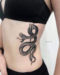 Snake Wrapped Around An Arrow Tattoo On The Left Side Snake Tattoo Wrap Around Mamba Tattoo Snake Tattoo Design