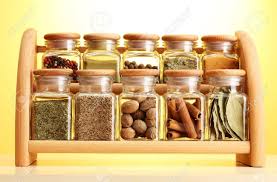 Powder Spices In Glass Jars On Wooden Shelf On Yellow Background Stock Photo Picture And Royalty Free Image Image 14369261