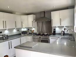 We loved the shade of the gray in this grey shaker kitchen cabinet! Grey Supernova Quartz Kitchen Design Small Grey Worktop Grey Kitchens