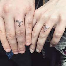 16 Wedding Ring Tattoos We Kind Of Love Tattoo Wedding Rings Wedding Ring Tattoo For Men Ring Tattoos