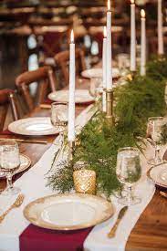 Pine Branches And Burgundy Hues For An Elegant Winter Wedding Winter Wedding Table Elegant Winter Wedding Candle Wedding Centerpieces