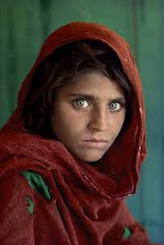 Photo of ten year old refugee girl, Sharbat Gula, known for her piercing  green eyes, and often referred to as "The Afghan Girl." The photo was taken  by photographer, Steve McCurry in
