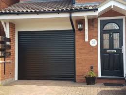 garage door finished in black roller shutter door insulated remote control actuation with safety bottom brick exterior house garage doors house paint exterior
