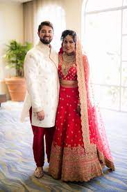 Bride And Groom In Traditional Indian Wedding Attire Bride In Lehnga And Groom In Sherwani Indian Wedding Couple Couple Wedding Dress Indian Wedding