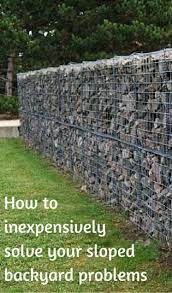 How To Inexpensively Solve Your Sloped Backyard Problems Sloped Backyard Sloped Backyard Landscaping Sloped Garden