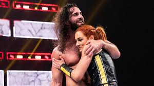 Becky Lynch & Seth Rollins Pose With WWE Title Belts In Risqué Photo;  Fellow Superstars React