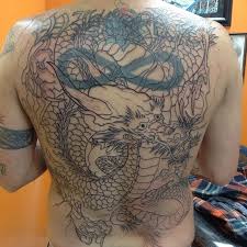 This tattoo used a heroic amount of detail to cover up the previous tattoo. Steve Schram Tattoos More Covering Up The Old Whore Back Dragon Tattoo