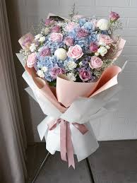 Pink and peach roses are arranged with a green hydrangea plant for delivery in a square paper floral decorated pot cover. Pre Order Vanilla Sky Opening Flower Stand å¼€å¼ èŠ± Scentales Florist