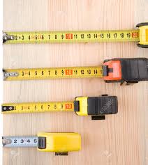 The inch ruler, which has 12 big numbers on it (1 for each inch), and the metric ruler, which has 30 big numbers on it (1 for . Tape Measure On Wood Brick Solated At White Background Stock Photo Picture And Royalty Free Image Image 11719097