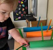 Counting activity with paper towel rolls and popsicle sticks