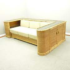 Vintage sectional sofa constructed from oversized bamboo features two separate sections and large, comfortable cushions. German Art Deco Rattan Bamboo Sofa Daybed From Arco 1940s 163943
