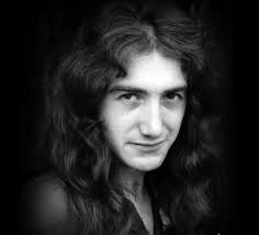 For the first time in three decades, Queen's elusive bassist John Deacon  has rejoined Brian May and Roger Taylor—if only to sign a new autograph for  a charity auction. The moment, tied