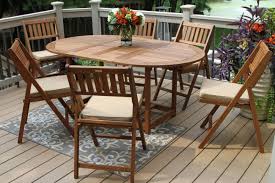 Folding wood patio table and chairs. 7pc Eucalyptus Oval Fold Store Dining Set With Biege Cushions