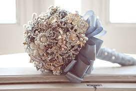 After that, take your floral wire and divide it in half like your pipe cleaner. Diy Brooch Wedding Bouquet Made Of Vintage Family Brooches And Pearls Jeweled Bouquet Vintage Bouquet Wedding Brooch Bouquet Diy