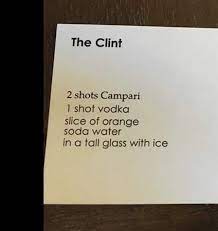 The bartender examines the card and nods his head. The Clint Using Campari Campari Drink Up Clint