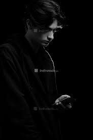 Ships from and sold by amazon.com. Young Guy In A Black Hoodie On A Black Background With A Mobile Phone In His Hands People Indivstock