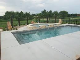 Shoreline model of blue hawaiian fiberglass pools, wrapped in real tile, and a stampcrete pool deck. Claremount Fiberglass Pool With Semicircle Spillover Spa Modern Pool Austin By Aquamarine Pools Of Texas Houzz