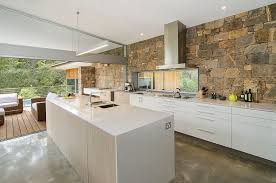 Her project repurposes wood from an old privacy fence. Stone Wall Connects The Kitchen With The Pool Deck Outside Design Rodrigues Bodycoat Architects Kitchen Stone Wall Rustic Kitchen Design Kitchen Feature Wall