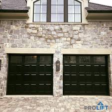 Darker Colors Are Taking The Stage For Garage Doors In 2019 How To Choose A Color For Your Custom Wood Garage Doors Wooden Garage Doors Garage Door Paint