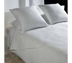 Boy's bedroom features white linen beds with gray pom pom duvet covers, a shared gray dresser as a nightstand lit by black lamps with white lampshades, black and white wallpaper, and a black and white corner accent chair over a black and white rug. Alina Bedspread