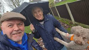 Working Together Out and About in the rain this morning with a resident  lookibg at pavement and tree issues