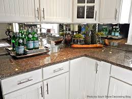 In this kitchen, elegant cherry cabinets and sleek surfaces lend a stylish, contemporary appearance. Small Kitchen Mirrored Backsplash Kitchen Novocom Top