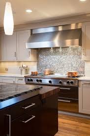 We normally see penny tile in the bathroom; 12 Glowing Silver Penny Tile Backsplash Looks Great With A Stainless Steel Hood Digsdigs Kitchen Design Kitchen Design Small Backsplash Tile Design