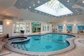 This indoor swimming pool is specially designed with a large glass in front of it. 20 Homes With Beautiful Indoor Swimming Pool Designs Indoor Swimming Pool Design Indoor Pool House Luxury Swimming Pools