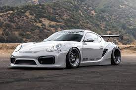 This Widebody Porsche Cayman 987 Is Wild As Weve Come To Expect From The Designers Of Rocket Bunny Kits Porsche Porsche Cayman S Rocket Bunny Kit