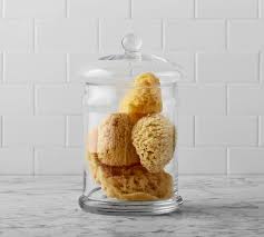 Another excellent organization hack is using vanity trays made of wood and acrylic. Classic Glass Bathroom Canisters Pottery Barn