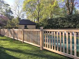 An uninterrupted line of boards stretches as far as the fence line runs with supporting posts. Wood Fencing In Suffolk County Sunrise Custom Fence
