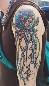 My Tattoo Mandala Style Lotus Flower Jellyfish There Is Also A Rainbow Feather That Comes Down Around My Forearm That S Co Boho Tattoos Street Tattoo Tattoos