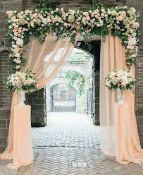 This rustic entryway decor arrangement uses a muted color palette that features muted silver picture frames bookended by a silver lamp and vase at the ends. Top 20 Wedding Entrance Decoration Ideas For Your Reception Emmalovesweddings