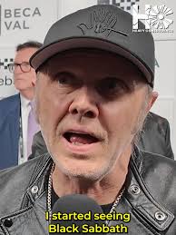 Chad Smith of Red Hot Chili Peppers watches a busker performing his so...