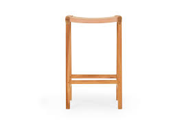 The metal base features four slim legs with crossbars that provide extra support and a spot where you can rest your feet. Cuba Barstool Nude Leather Solid Wood Lounge Lovers