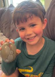 Pink rock hidden by downtown cross street