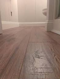 Home Decorators Collection Distressed Brown Hickory 12 Mm X 6 1 X2f 4 In X 50 25 X2f 32 In Laminate Distressed Laminate Flooring Flooring Laminate Flooring