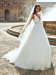 Beautiful young woman with perfect make up leaning her head on her hand thoughfully. Princess Sleeveless Wedding Dress With Plunging Neckline And Lace Kleinfeld Bridal