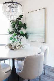 Elegant Dining Room Featuring A Restoration Hardware 1920s Odeon Clear Glass Fringe 3 Tier Ch Round Dining Room Table Round Dining Room Marble Top Dining Table