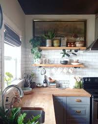 What A Gorgeous Kitchen Counter Love The Natural Wood Butcher Block The Open Shelving And Vintage Picture On Top Shelf With All The Indoor Plants Are Awesome In 2020 Moderne