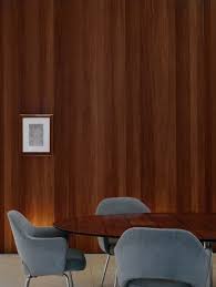 blue saarinen chairs tropical wood in casa corten by marcio kogan