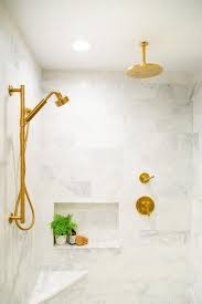 Marble Clad Walk In Shower Boasts A Brushed Gold Shower Head Fixed To Marble Surround Tiles Facing A Round Gold Ra White Marble Shower Gold Shower Shower Heads