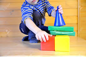 Different types of houses are used for the coloring pages depicting various forms of houses are interesting to color as they give your kids. A Child In A Striped Shirt The Kid Builds A House With The Multi Colored Stock Photo Picture And Royalty Free Image Image 89621329