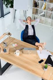 Who should sit at your head table at your wedding reception? Young Businesswoman Sitting At Desk In Office With Feet On Table Stock Photo Picture And Royalty Free Image Image 102327903