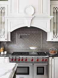 White wood range hood with a white herringbone backsplash and a swing arm pot filler over a range in a transitional kitchen. 75 Amazing Kitchen Backsplash Ideas Kitchen Backsplash Designs Kitchen Remodel Kitchen Tiles Backsplash