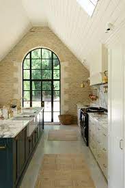 With a white background, the color of the plants stands out, creating very interesting focal points while still maintaining simplicity. Large Kitchen Window Design Ideas Heather Hungeling Design